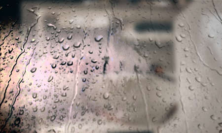Background with rain drops close up. Rain drops on outdoor window, Closeup view transparent water drops on glass surface, humid water backdrop, blurred background with copy space for your textの写真素材