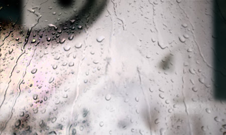 Background with rain drops close up. Rain drops on outdoor window, Closeup view transparent water drops on glass surface, humid water backdrop, blurred background with copy space for your textの写真素材