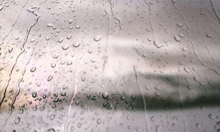 Background with rain drops close up. Rain drops on outdoor window, Closeup view transparent water drops on glass surface, humid water backdrop, blurred background with copy space for your textの写真素材