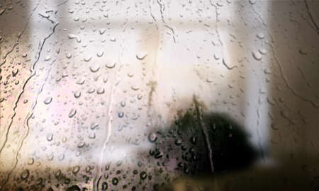 Background with rain drops close up. Rain drops on outdoor window, Closeup view transparent water drops on glass surface, humid water backdrop, blurred background with copy space for your textの写真素材