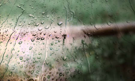 Background with rain drops close up. Rain drops on outdoor window, Closeup view transparent water drops on glass surface, humid water backdrop, blurred background with copy space for your textの写真素材