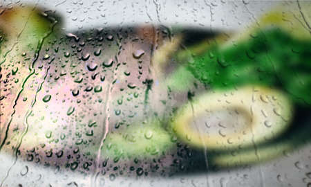 Background with rain drops close up. Rain drops on outdoor window, Closeup view transparent water drops on glass surface, humid water backdrop, blurred background with copy space for your textの写真素材