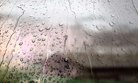 Background with rain drops close up. Rain drops on outdoor window, Closeup view transparent water drops on glass surface, humid water backdrop, blurred background with copy space for your textの写真素材