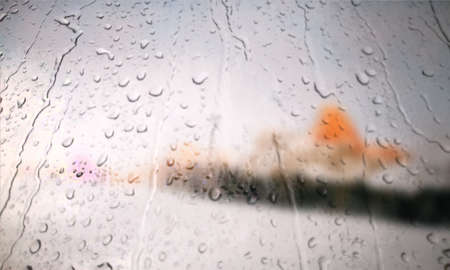 Background with rain drops close up. Rain drops on outdoor window, Closeup view transparent water drops on glass surface, humid water backdrop, blurred background with copy space for your textの写真素材