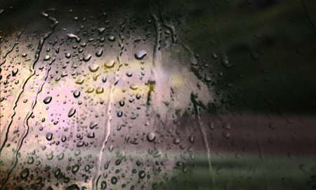 Background with rain drops close up. Rain drops on outdoor window, Closeup view transparent water drops on glass surface, humid water backdrop, blurred background with copy space for your textの写真素材