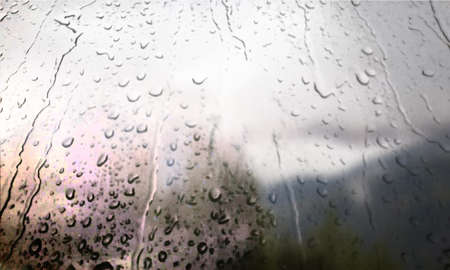 Background with rain drops close up. Rain drops on outdoor window, Closeup view transparent water drops on glass surface, humid water backdrop, blurred background with copy space for your textの写真素材
