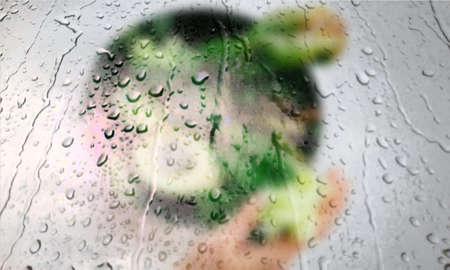 Background with rain drops close up. Rain drops on outdoor window, Closeup view transparent water drops on glass surface, humid water backdrop, blurred background with copy space for your textの写真素材