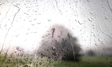 Background with rain drops close up. Rain drops on outdoor window, Closeup view transparent water drops on glass surface, humid water backdrop, blurred background with copy space for your textの写真素材