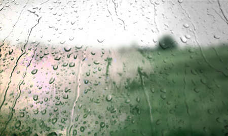 Background with rain drops close up. Rain drops on outdoor window, Closeup view transparent water drops on glass surface, humid water backdrop, blurred background with copy space for your textの写真素材