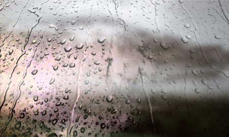 Background with rain drops close up. Rain drops on outdoor window, Closeup view transparent water drops on glass surface, humid water backdrop, blurred background with copy space for your textの写真素材