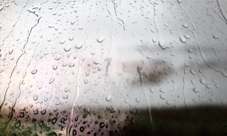Background with rain drops close up. Rain drops on outdoor window, Closeup view transparent water drops on glass surface, humid water backdrop, blurred background with copy space for your textの写真素材