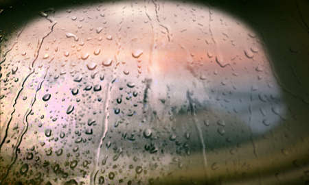 Background with rain drops close up. Rain drops on outdoor window, Closeup view transparent water drops on glass surface, humid water backdrop, blurred background with copy space for your textの写真素材