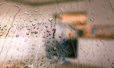 Background with rain drops close up. Rain drops on outdoor window, Closeup view transparent water drops on glass surface, humid water backdrop, blurred background with copy space for your textの写真素材