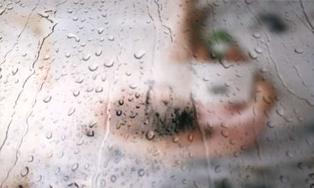 Background with rain drops close up. Rain drops on outdoor window, Closeup view transparent water drops on glass surface, humid water backdrop, blurred background with copy space for your textの写真素材