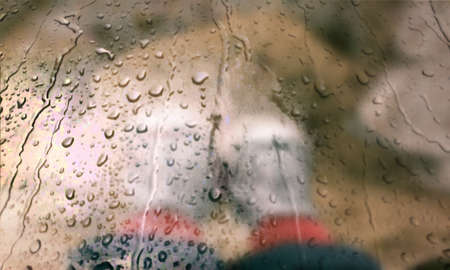 Background with rain drops close up. Rain drops on outdoor window, Closeup view transparent water drops on glass surface, humid water backdrop, blurred background with copy space for your textの写真素材