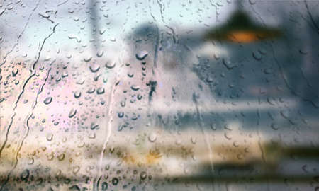 Background with rain drops close up. Rain drops on outdoor window, Closeup view transparent water drops on glass surface, humid water backdrop, blurred background with copy space for your textの写真素材