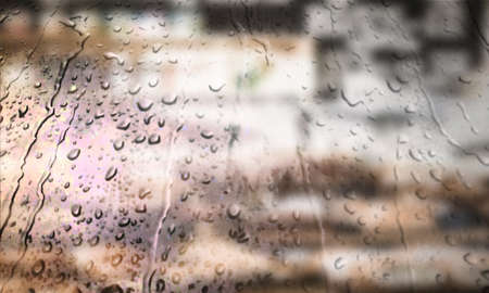 Background with rain drops close up. Rain drops on outdoor window, Closeup view transparent water drops on glass surface, humid water backdrop, blurred background with copy space for your textの写真素材