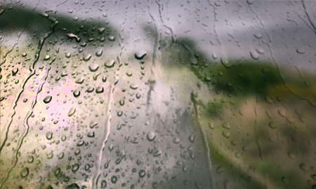 Background with rain drops close up. Rain drops on outdoor window, Closeup view transparent water drops on glass surface, humid water backdrop, blurred background with copy space for your textの写真素材