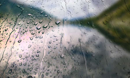 Background with rain drops close up. Rain drops on outdoor window, Closeup view transparent water drops on glass surface, humid water backdrop, blurred background with copy space for your textの写真素材
