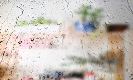Background with rain drops close up. Rain drops on outdoor window, Closeup view transparent water drops on glass surface, humid water backdrop, blurred background with copy space for your textの写真素材