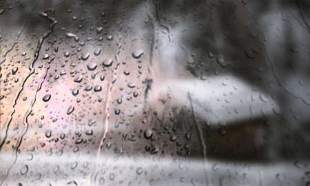 Background with rain drops close up. Rain drops on outdoor window, Closeup view transparent water drops on glass surface, humid water backdrop, blurred background with copy space for your textの写真素材