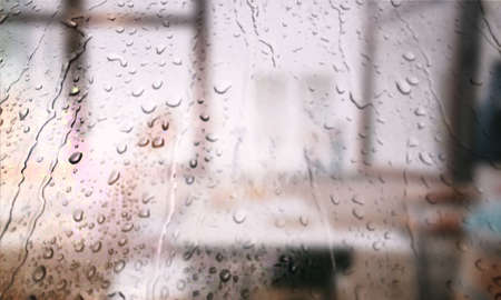 Background with rain drops close up. Rain drops on outdoor window, Closeup view transparent water drops on glass surface, humid water backdrop, blurred background with copy space for your textの写真素材