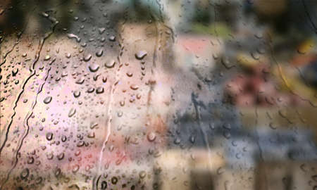 Background with rain drops close up. Rain drops on outdoor window, Closeup view transparent water drops on glass surface, humid water backdrop, blurred background with copy space for your textの写真素材