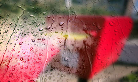 Background with rain drops close up. Rain drops on outdoor window, Closeup view transparent water drops on glass surface, humid water backdrop, blurred background with copy space for your textの写真素材