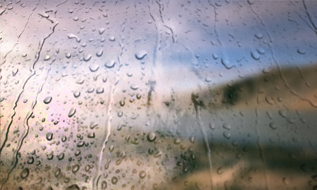 Background with rain drops close up. Rain drops on outdoor window, Closeup view transparent water drops on glass surface, humid water backdrop, blurred background with copy space for your textの写真素材