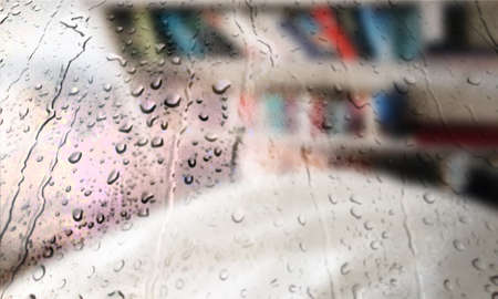 Background with rain drops close up. Rain drops on outdoor window, Closeup view transparent water drops on glass surface, humid water backdrop, blurred background with copy space for your textの写真素材