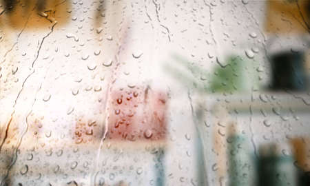 Background with rain drops close up. Rain drops on outdoor window, Closeup view transparent water drops on glass surface, humid water backdrop, blurred background with copy space for your textの写真素材