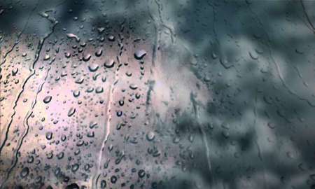 Background with rain drops close up. Rain drops on outdoor window, Closeup view transparent water drops on glass surface, humid water backdrop, blurred background with copy space for your textの写真素材