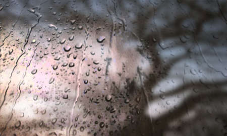 Background with rain drops close up. Rain drops on outdoor window, Closeup view transparent water drops on glass surface, humid water backdrop, blurred background with copy space for your textの写真素材