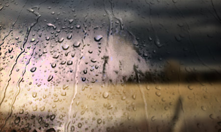 Background with rain drops close up. Rain drops on outdoor window, Closeup view transparent water drops on glass surface, humid water backdrop, blurred background with copy space for your textの写真素材