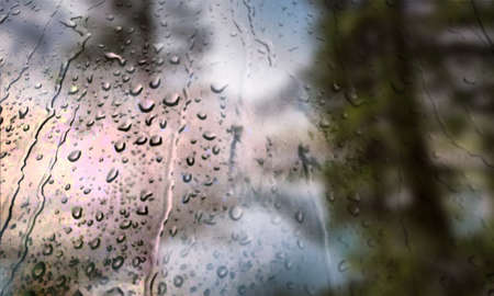 Background with rain drops close up. Rain drops on outdoor window, Closeup view transparent water drops on glass surface, humid water backdrop, blurred background with copy space for your textの写真素材