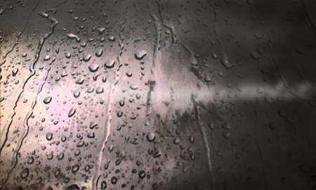 Background with rain drops close up. Rain drops on outdoor window, Closeup view transparent water drops on glass surface, humid water backdrop, blurred background with copy space for your textの写真素材