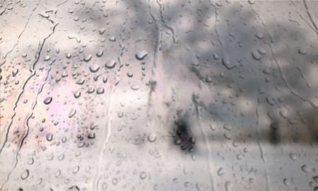 Background with rain drops close up. Rain drops on outdoor window, Closeup view transparent water drops on glass surface, humid water backdrop, blurred background with copy space for your textの写真素材