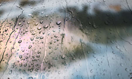 Background with rain drops close up. Rain drops on outdoor window, Closeup view transparent water drops on glass surface, humid water backdrop, blurred background with copy space for your textの写真素材