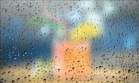 Background with rain drops close up. Rain drops on outdoor window, Closeup view transparent water drops on glass surface, humid water backdrop, blurred background with copy space for your textの写真素材