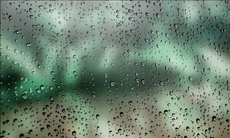 Background with rain drops close up. Rain drops on outdoor window, Closeup view transparent water drops on glass surface, humid water backdrop, blurred background with copy space for your textの写真素材