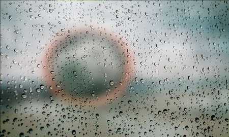 Background with rain drops close up. Rain drops on outdoor window, Closeup view transparent water drops on glass surface, humid water backdrop, blurred background with copy space for your textの写真素材