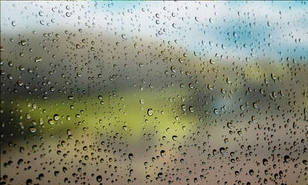 Background with rain drops close up. Rain drops on outdoor window, Closeup view transparent water drops on glass surface, humid water backdrop, blurred background with copy space for your textの写真素材