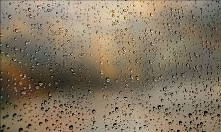 Background with rain drops close up. Rain drops on outdoor window, Closeup view transparent water drops on glass surface, humid water backdrop, blurred background with copy space for your textの写真素材