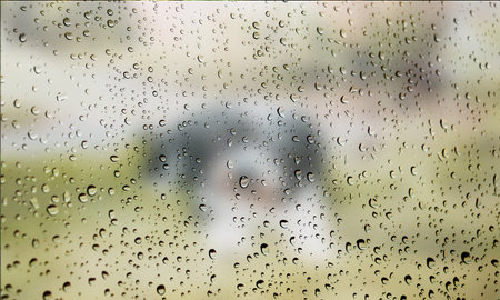 Background with rain drops close up. Rain drops on outdoor window, Closeup view transparent water drops on glass surface, humid water backdrop, blurred background with copy space for your textの写真素材