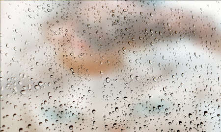 Background with rain drops close up. Rain drops on outdoor window, Closeup view transparent water drops on glass surface, humid water backdrop, blurred background with copy space for your textの写真素材