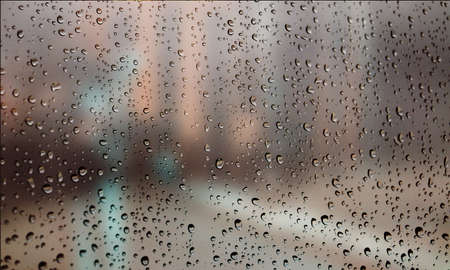 Background with rain drops close up. Rain drops on outdoor window, Closeup view transparent water drops on glass surface, humid water backdrop, blurred background with copy space for your textの写真素材