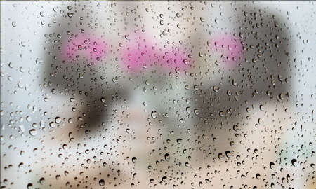 Background with rain drops close up. Rain drops on outdoor window, Closeup view transparent water drops on glass surface, humid water backdrop, blurred background with copy space for your textの写真素材