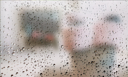 Background with rain drops close up. Rain drops on outdoor window, Closeup view transparent water drops on glass surface, humid water backdrop, blurred background with copy space for your textの写真素材