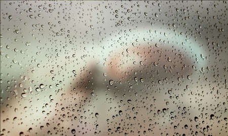 Background with rain drops close up. Rain drops on outdoor window, Closeup view transparent water drops on glass surface, humid water backdrop, blurred background with copy space for your textの写真素材