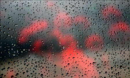 Background with rain drops close up. Rain drops on outdoor window, Closeup view transparent water drops on glass surface, humid water backdrop, blurred background with copy space for your textの写真素材
